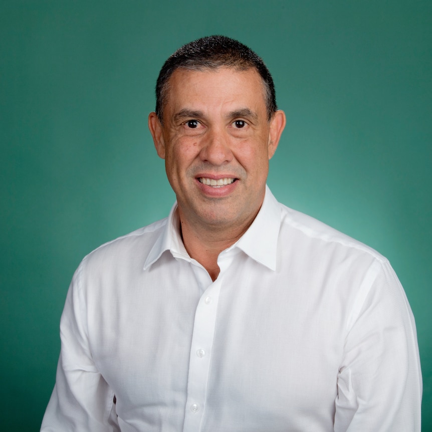 Man in white button up business shirt smiling