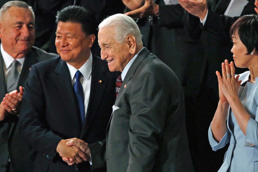 Retired Lt Gen Lawrence Snowden shakes hands with Yoshitaka Shindo.