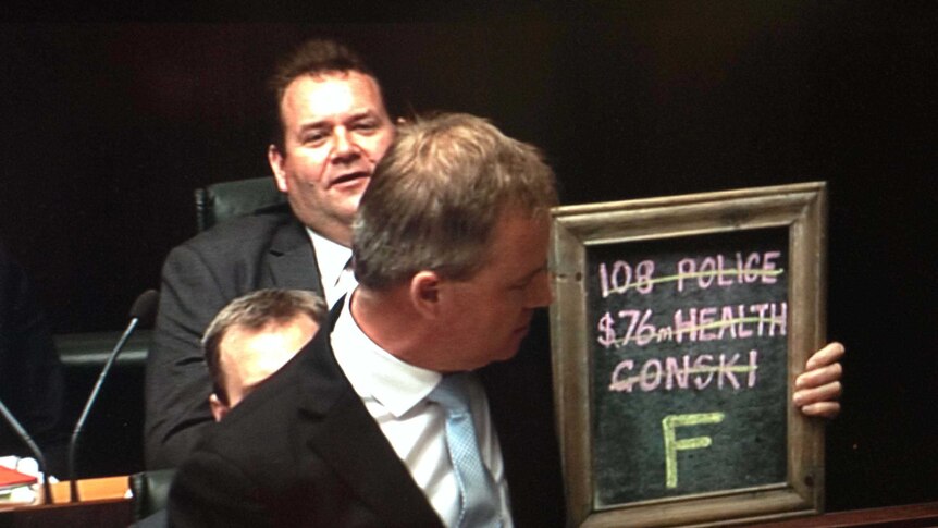 Tasmania's deputy premier Jeremy Rockliff holds a chalk board in the House of Assembly.