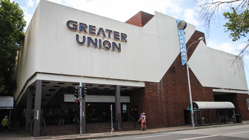 A brown and cream brick building with the words Greater Union written on it