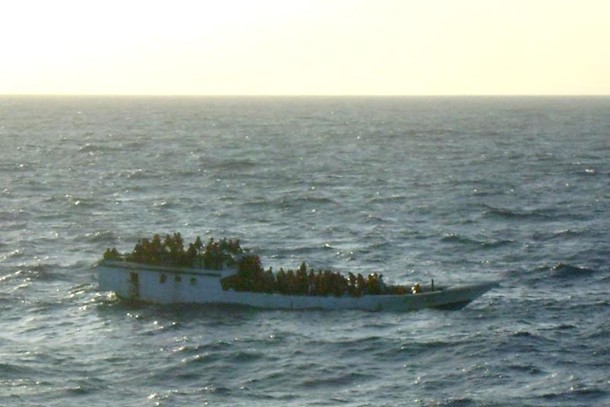Asylum seekers crowd the decks of their boat shortly before it sank. (AMSA)