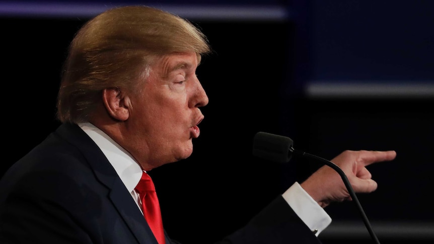 Donald Trump points at Hillary Clinton during the third presidential debate