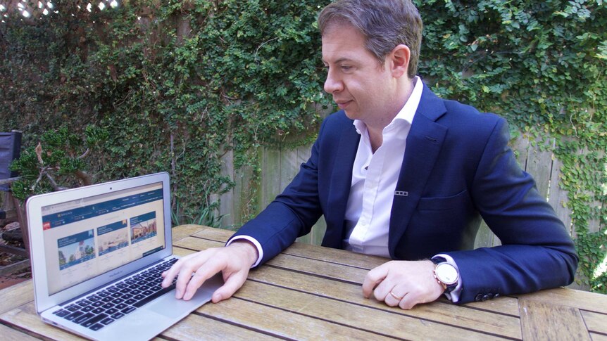 BrickX CEO Anthony Millet on a laptop.