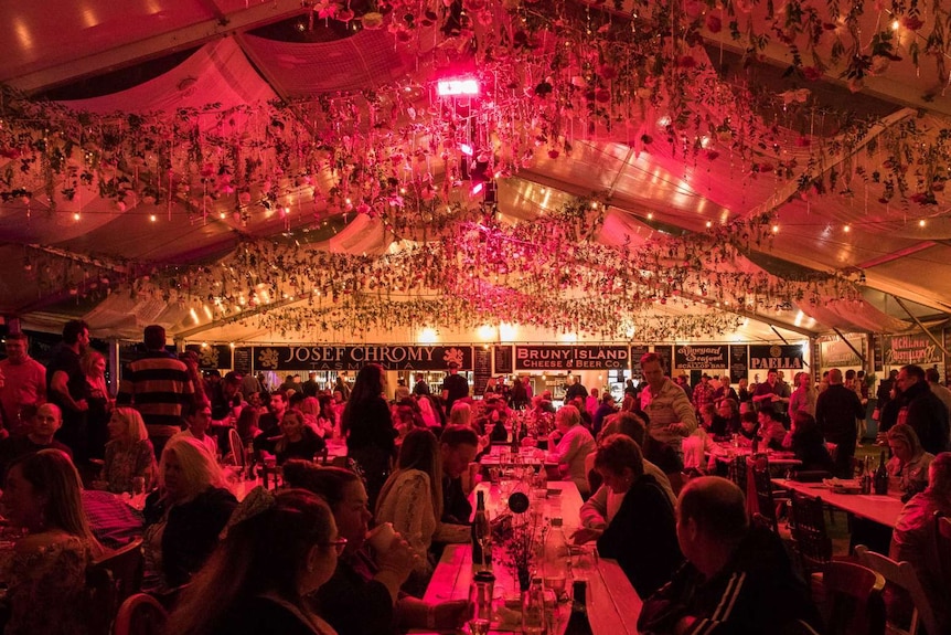 Diners in a marque at food festival.