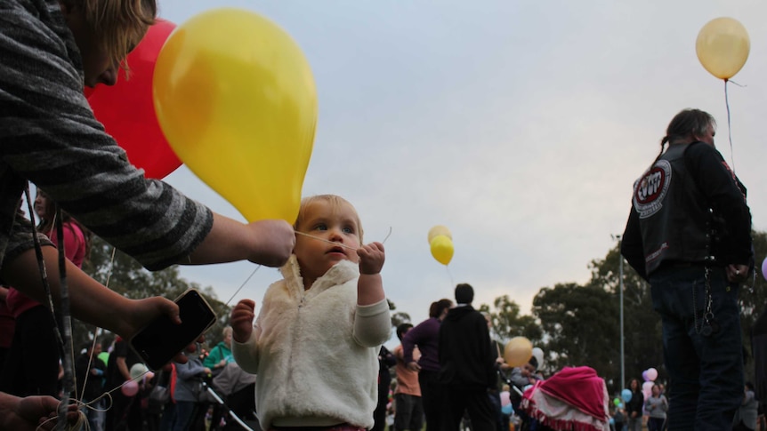 A child releases a balloon in Mildura in memory of Nikki Francis-Coslovich.