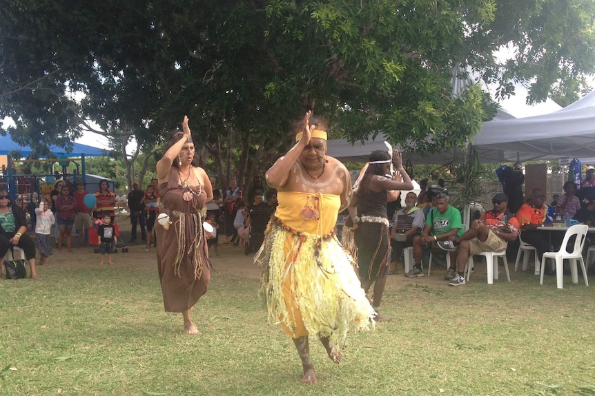 Dancers in cultural dress perform in Townsville in front of a crowd