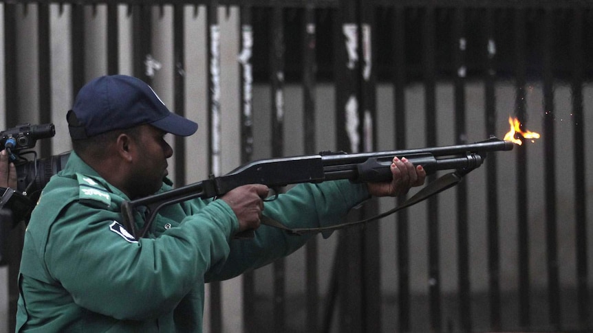 Bangladesh police officer fires rubber bullets