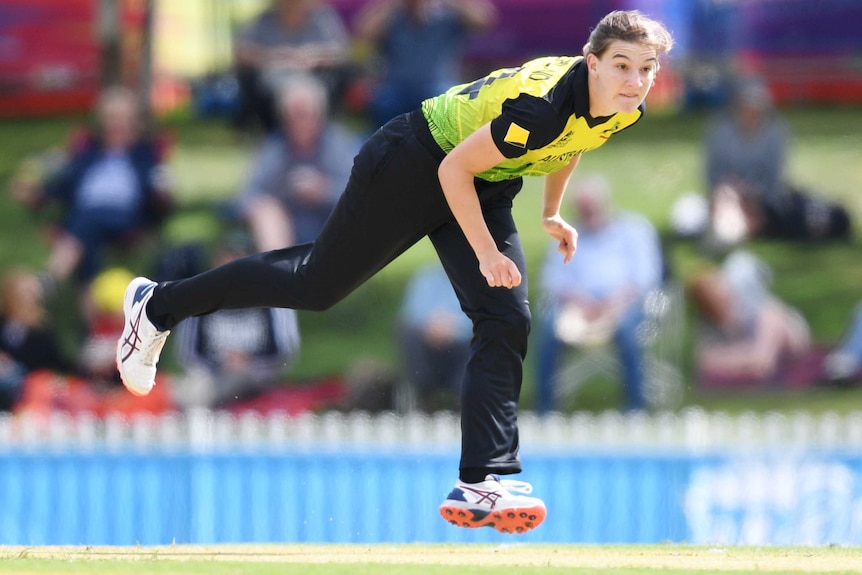 A female bowler is pictured in her follow-through during a World T20 World Cup warm-up match.