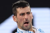 Novak Djokovic plays a forehand during his Australian Open match.