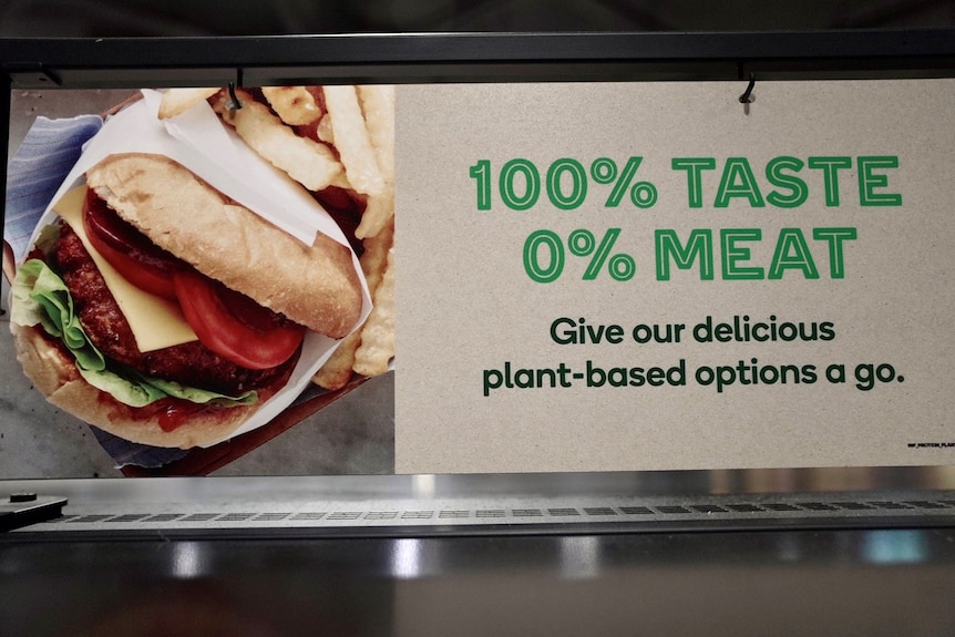 A picture of a sign advertising plant-based meat at Woolworths.