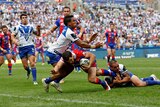 Jarrod Mullen dives through the tackles of Ben Barba and Dene Halatau to score.