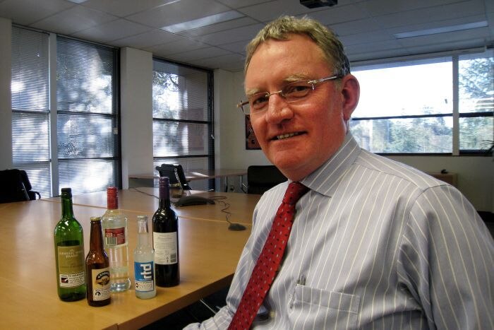 Michael Thorne sits next to empty alcohol bottles
