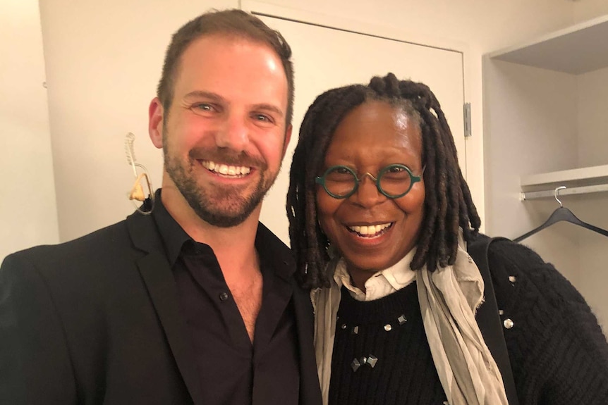 Nate Whitton stands next to Whoopi Goldberg