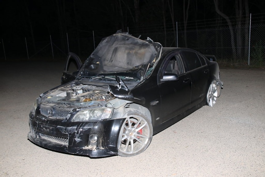 The black Holden Commodore, visibly damaged, allegedly used in a shooting rampage across Gympie at the weekend.