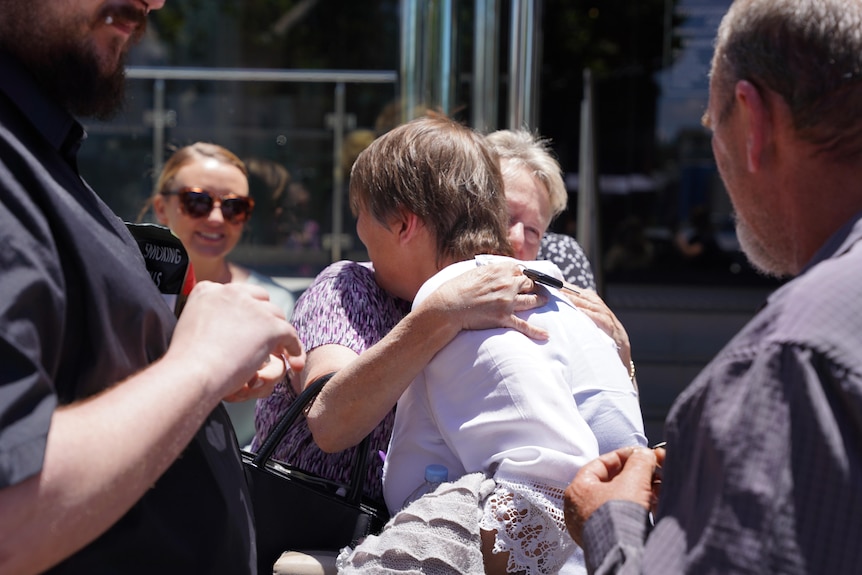 A woman being hugged