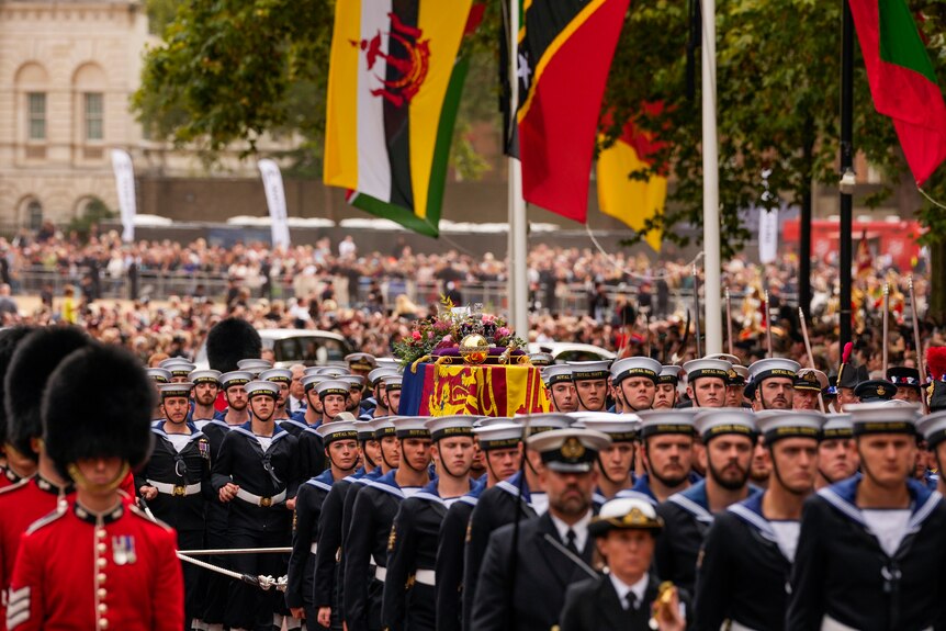 Members of the Royal Navy surround the Queen's coffin as it is carried away from Westminster Abbey. 