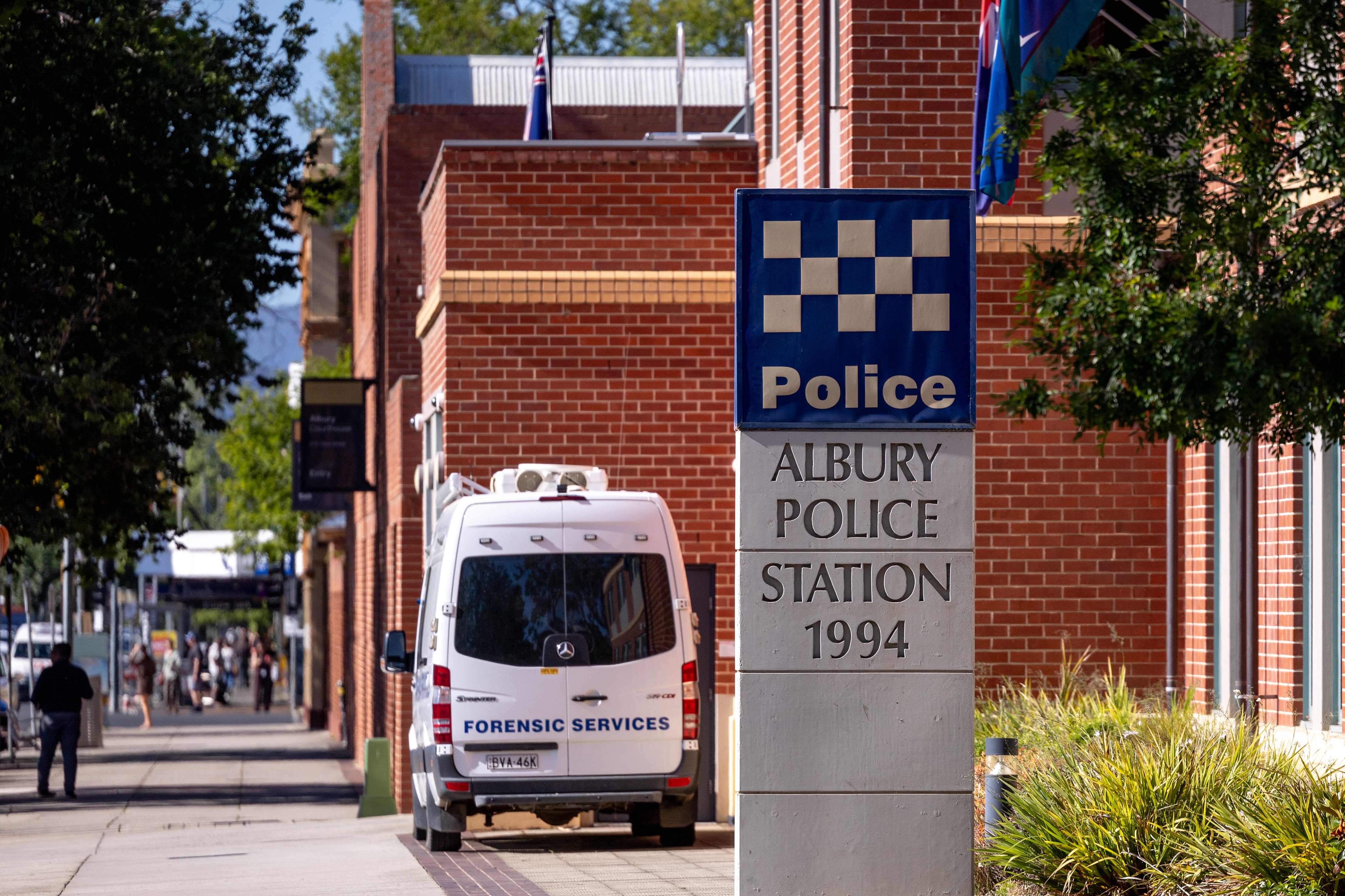 red brick building with police car