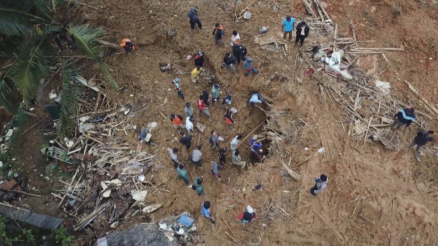 Locals dig for survivors and belongings in the thick mud