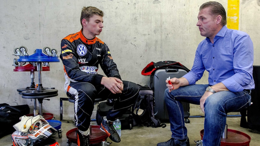 Dutch racing driver Max Verstappen (L) speaks to his father and former F1 driver Jos Verstappen (R).