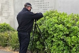 Forensic photographer at the scene where a man's body was found at Royal Hobart Hospital.