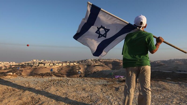 Israeli boy holds his national flag