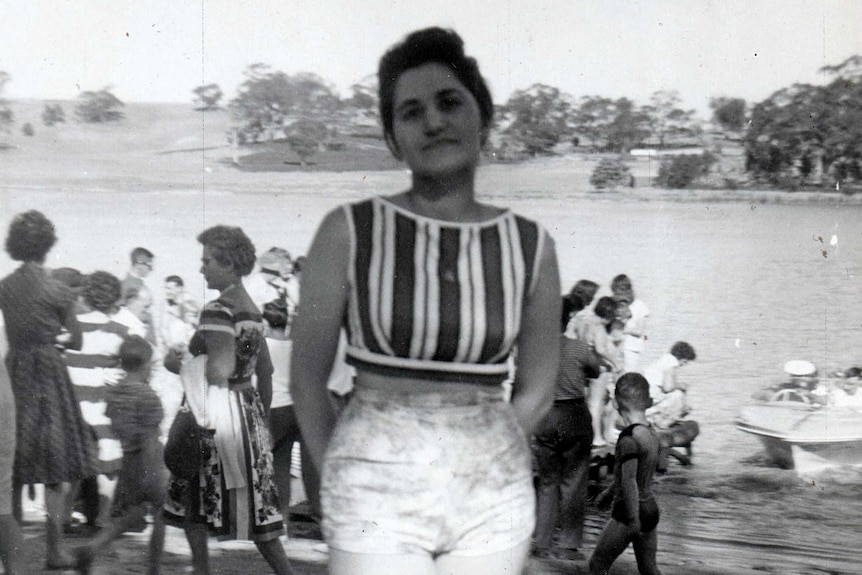 Maria James stands on the shore of a lake while on holiday.