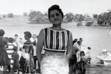 Maria James stands on the shore of a lake while on holiday.