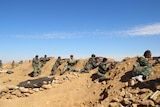 Syrian army soldiers take positions on the outskirts of Raqqa.