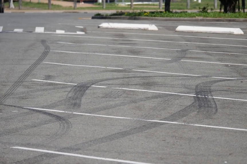 A carpark with burnout marks.
