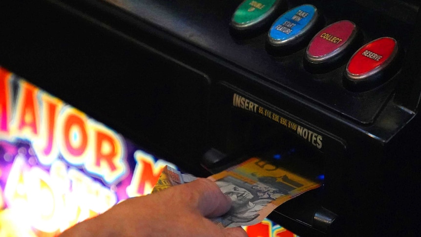 Cash being put in poker machine