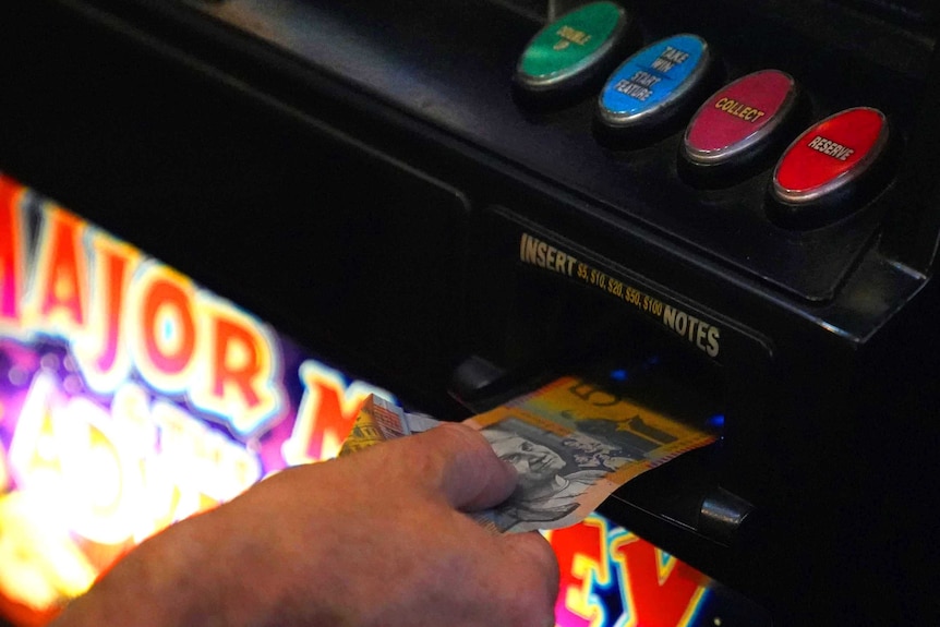 Cash being put in poker machine