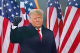 US President Donald Trump makes a fist during a rally in Washington