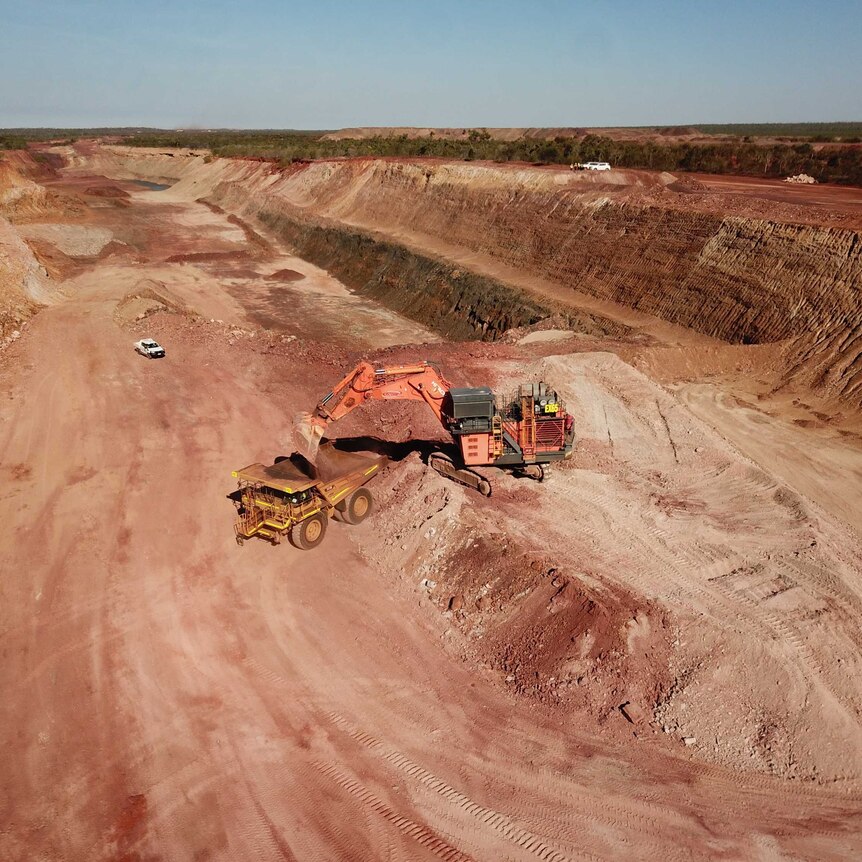 A haul truck is being loaded with iron ore in the open-pit of Roper Bar mine in the NT.