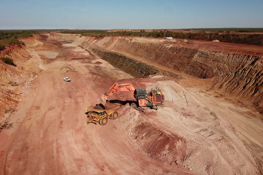 A haul truck is being loaded with iron ore in the open-pit of Roper Bar mine in the NT.