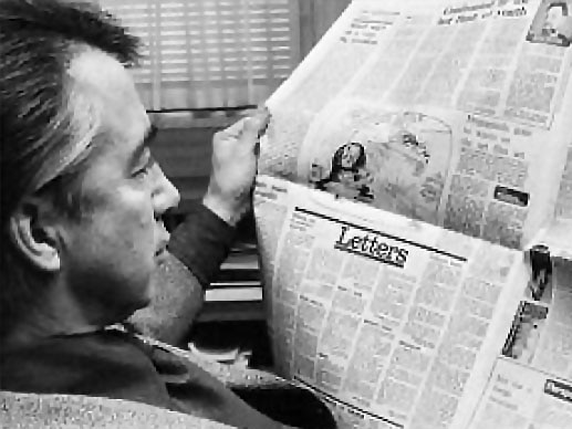 Don Dunstan reading newspaper