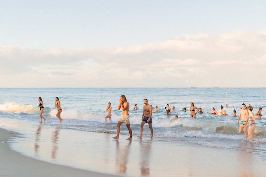 A group of young people swimming in the ocean.