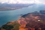 An aerial shot of a stretch of tropical coastline.