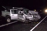 A ute and a van badly damaged at night