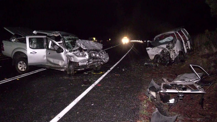 A ute and a van badly damaged at night