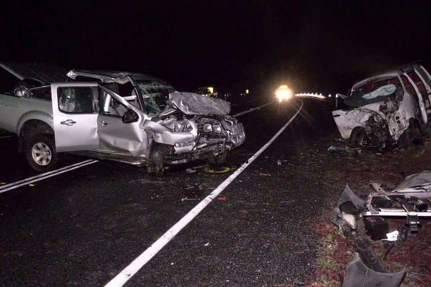 A ute and a van badly damaged at night