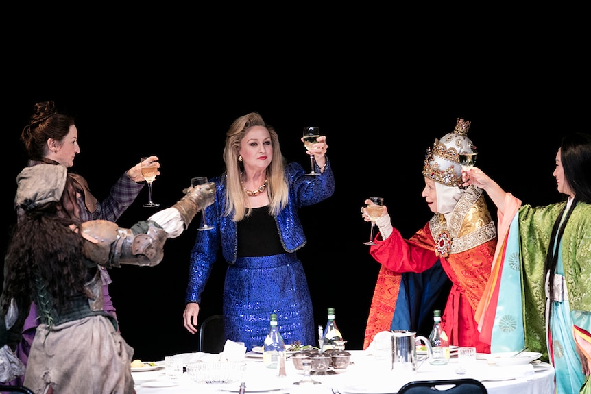 Colour production still of women toasting around a table on stage in 2018 Sydney Theatre Company production Top Girls.