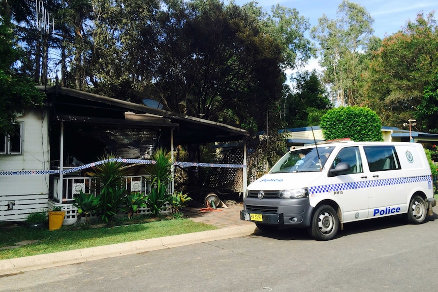 Police on the scene of a mobile home destroyed by fire in Port Macquarie's Lighthouse Beach Holiday Village.