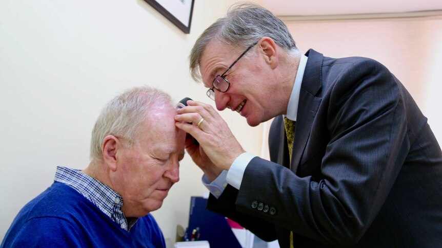 Dr Andrew Miller checks John Scott for skin cancer.