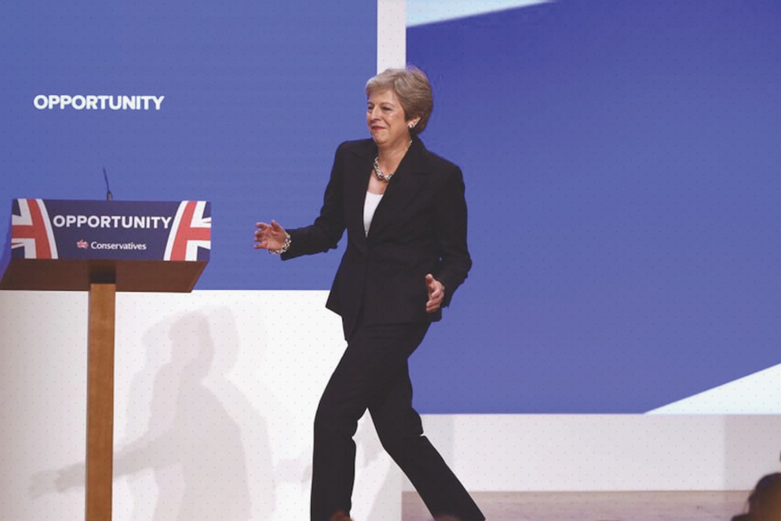 Theresa May dancing on stage.