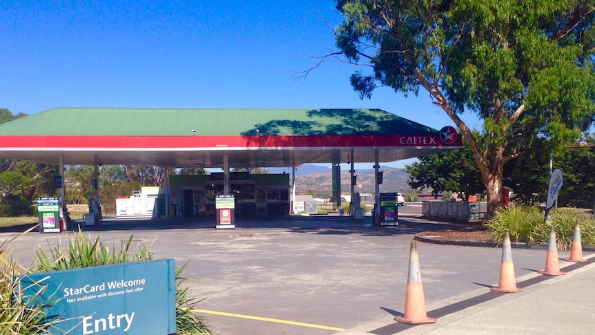 A petrol station with traffic cones blocking the entrance.