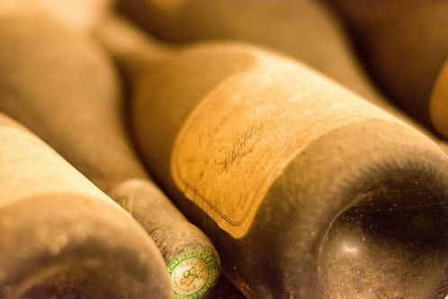 Dusty wine bottles stacked, good generic.