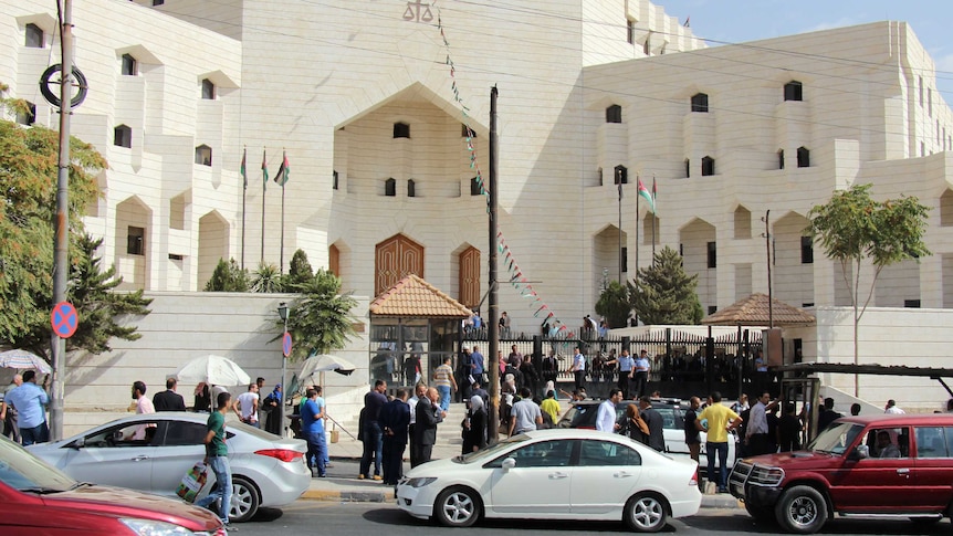 People gather outside a court in Jordan