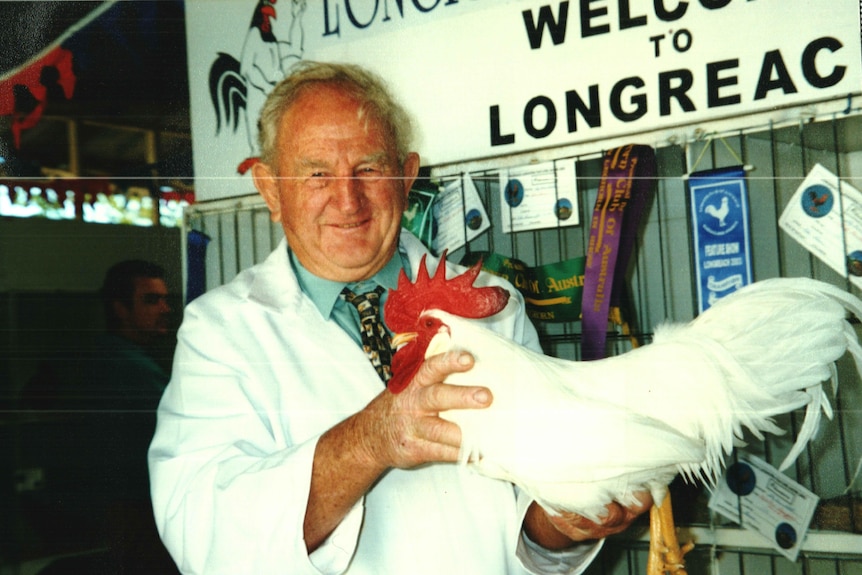  Grandpa John Arnett in a white coat with a chicken