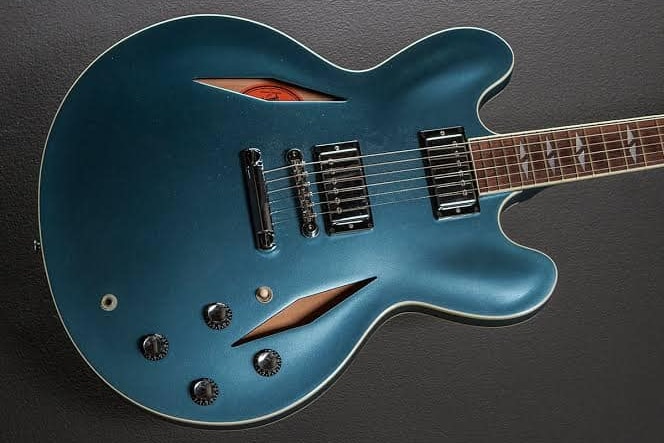 A blue guitar gleams.