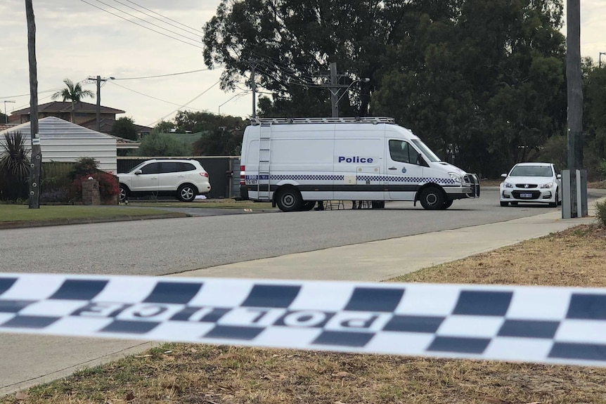 A police van parked outside a property and police tape in the foreground